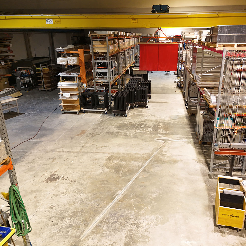 Organized production hall at ferry solutions with aluminum parts, shelves, and mobile workstations