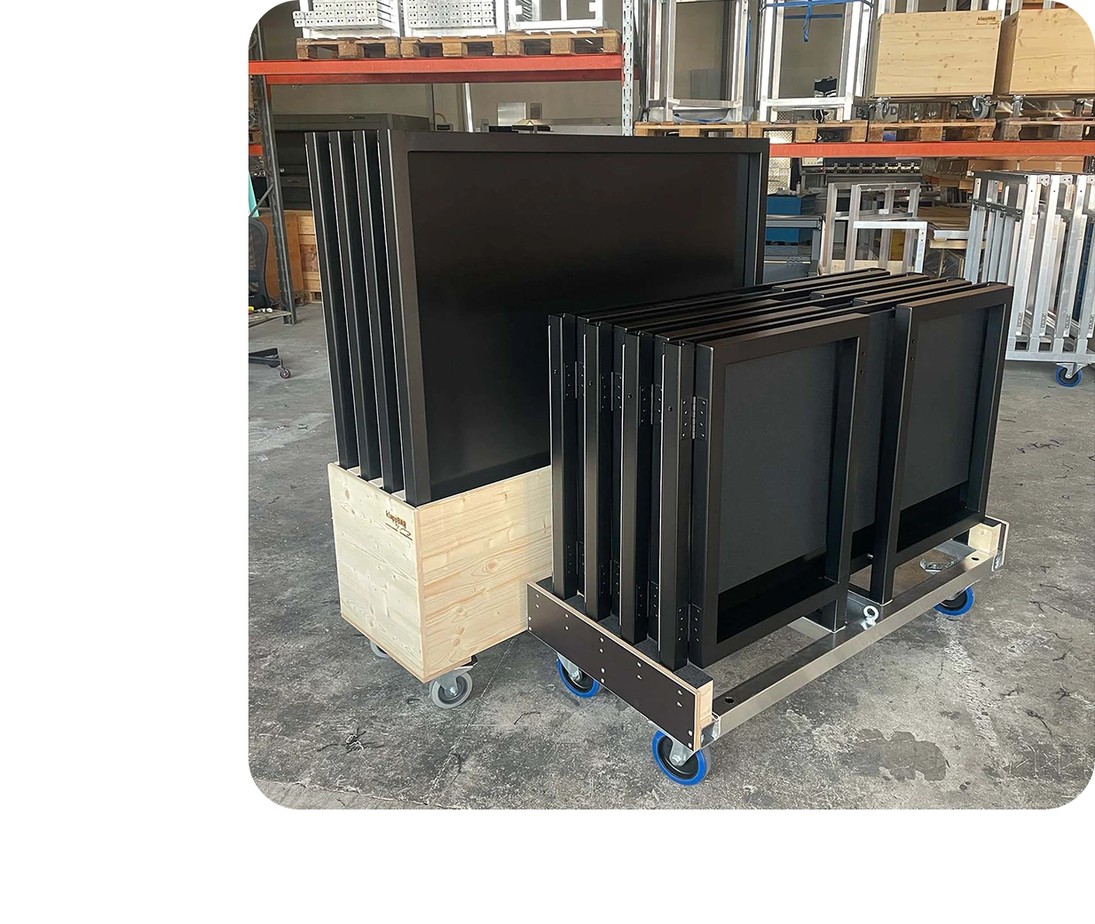 klappTISCH 1.2m units stacked on a transport cart inside our workshop in Wiener Nuestadt, Austria.
